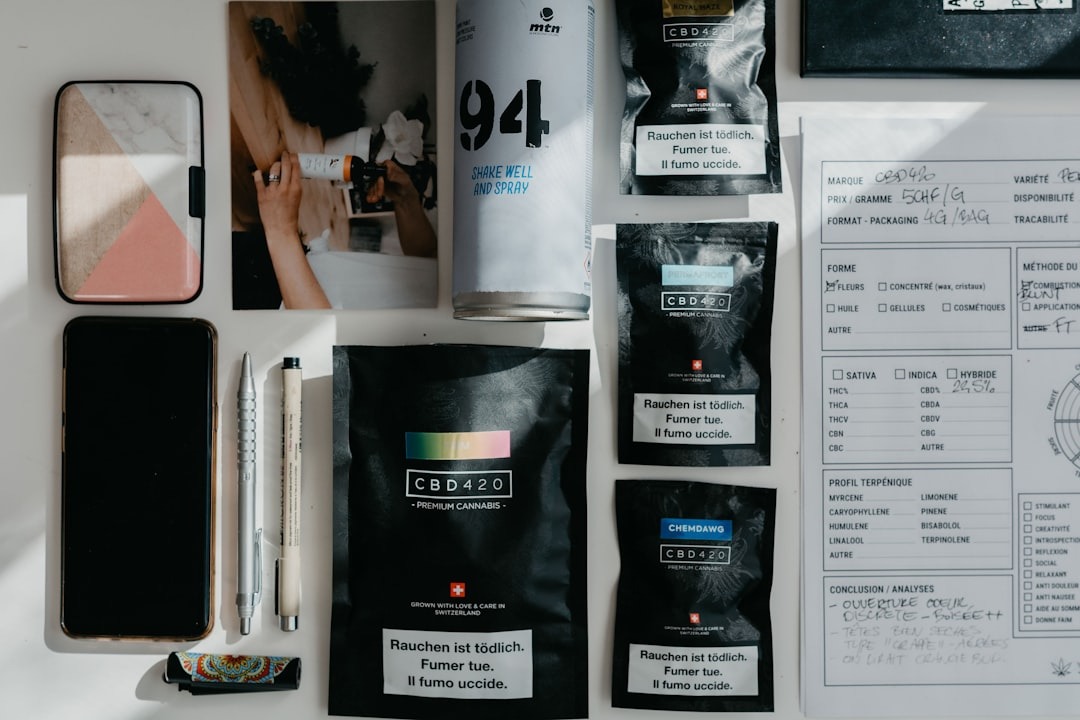 CBD 420 products and analysis notes laid out on white surface.