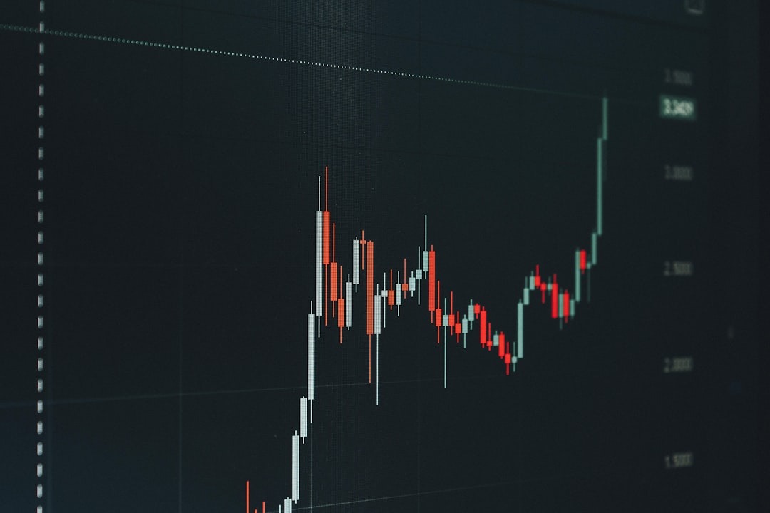 Digital screen displaying stock market candlestick chart.